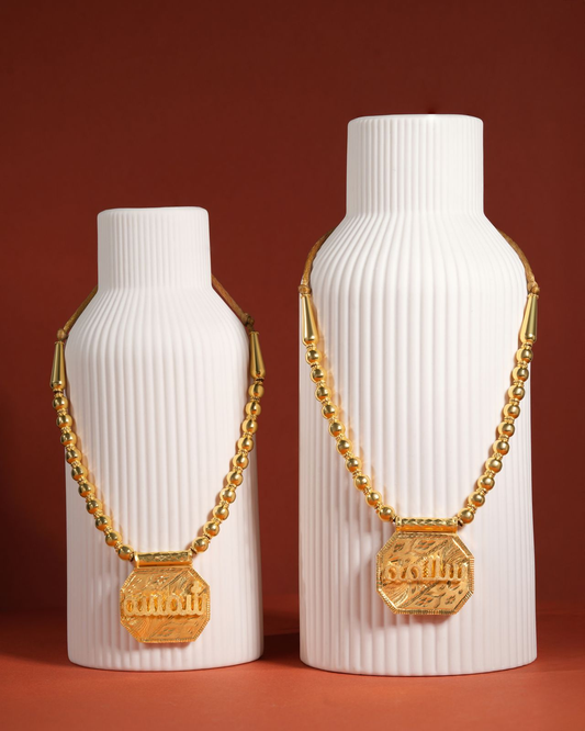 Eternal Modern Tabla ball-chain gold pendant necklace, front view on white ribbed stands