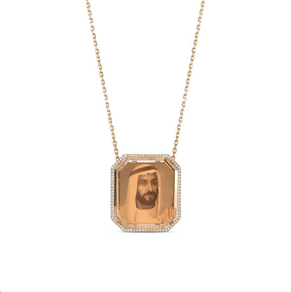 Octagonal gold pendant with faceted amber photo panel showing a male portrait, diamond halo on fine chain